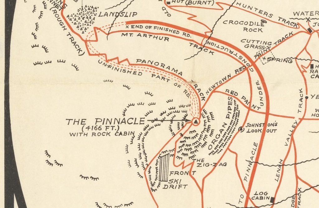 A close up of the Mt. Wellington Park, map of roads tracks. the middle of the image reads: the pinnacle (4166 FT.) with rock cabin. Leading from the pinnacle is a double dotted line indicating an unfinished road that connected to a road that is under construction.