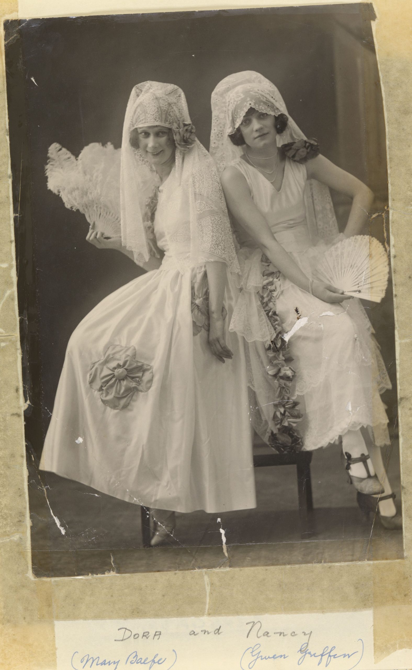An old photo of 2 women posing in bridal dresses.  Gwen Griffin as Dora and Nancy in the 1926 production of The Toreador