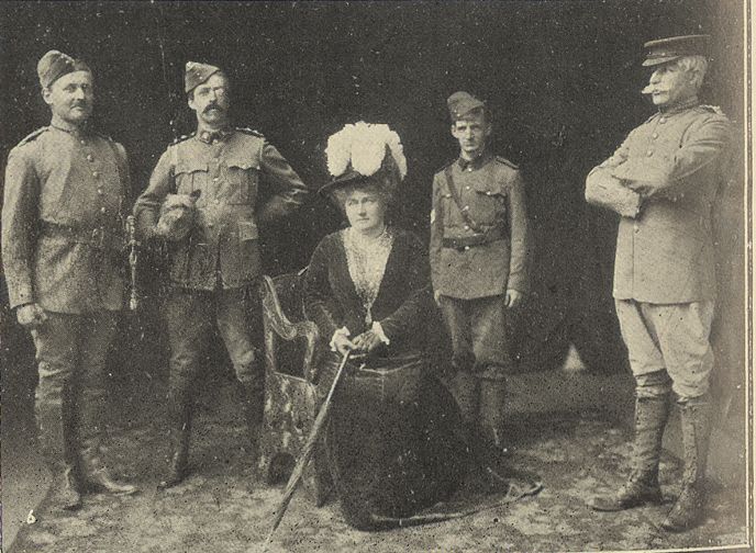 A picture of 4 people in costume from the musical Lady Madcap. 4 men dressed as hussars and one woman, Lucy Benson playing Mrs Layton