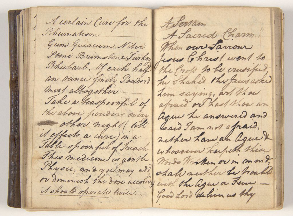 An open book with handwritten text. Text is illegible