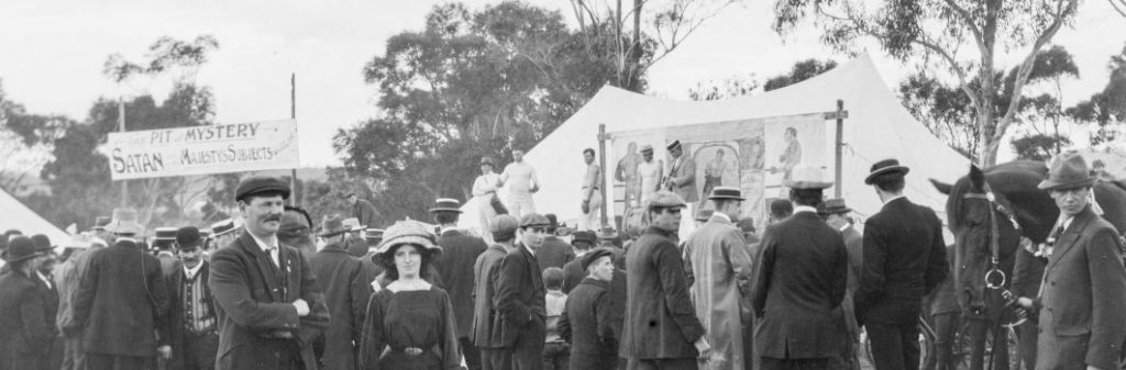 An old black and white photo of a crowd of people at a show.