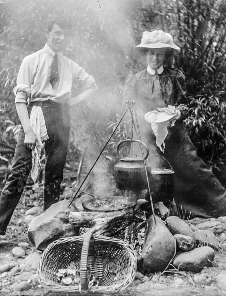 Photograph - Man and woman at an outdoor campfire