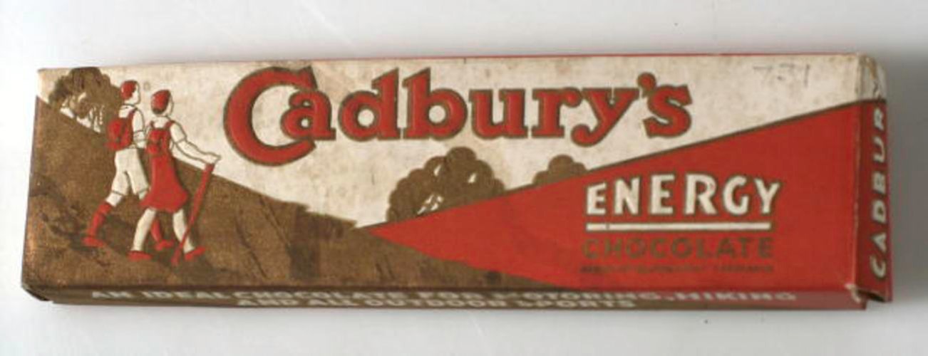 An old box that once contained Cadbury's chocolate. the box has a picture of 2 walkers with backpacks. the box reads.: "Cadbury's. Energy chocolate"