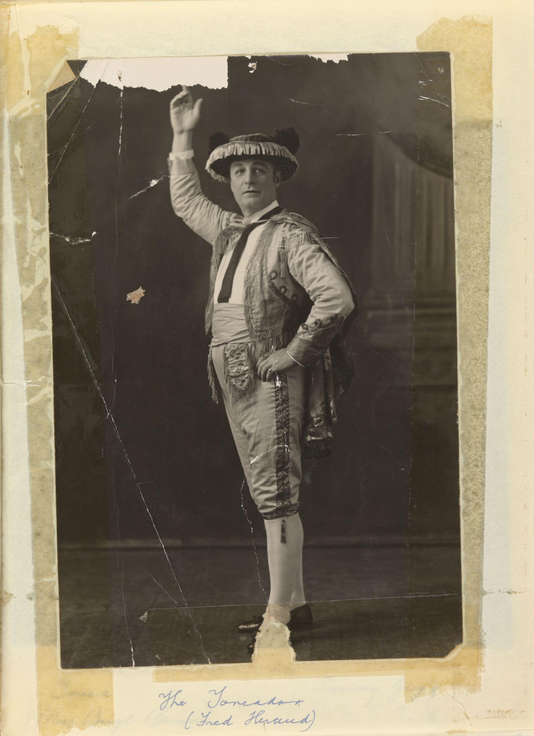 An old black and white photo of a man in a bull fighters uniform.