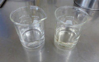 2 beakers. the left beaker has clean water. the right has dirty water.