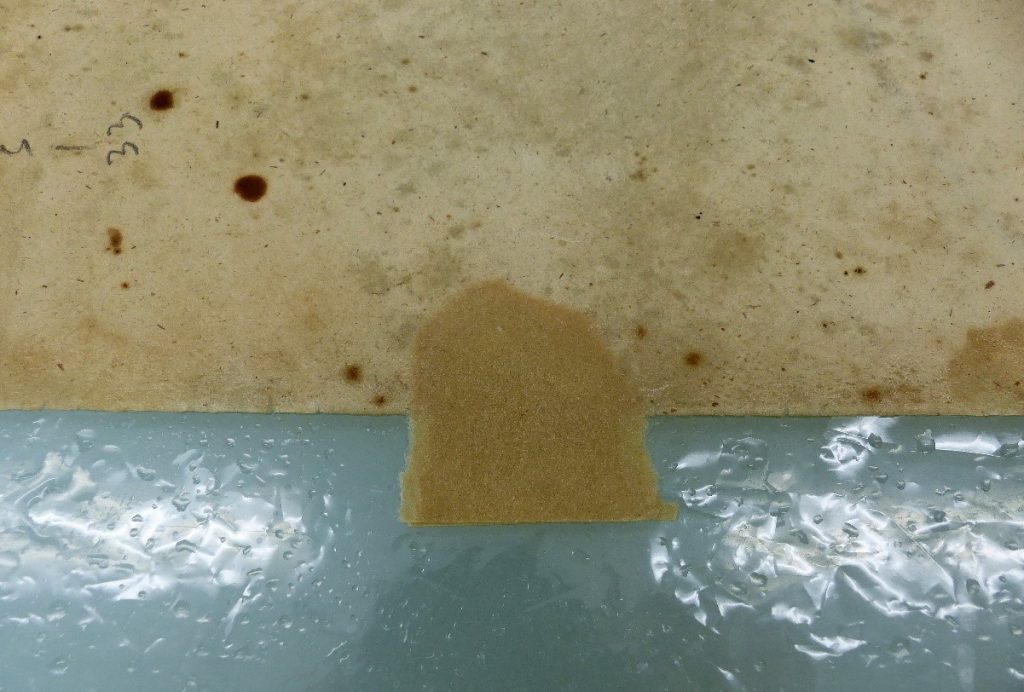 A part of the drawing with a repair patch to replace the missing piece.