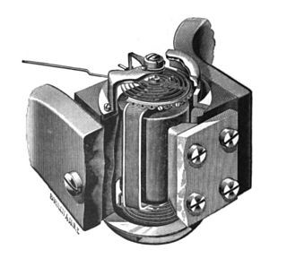 An early metal instrument for measuring electrical current.  A tube is encased in metal with a wire at the top with mounting brackets.